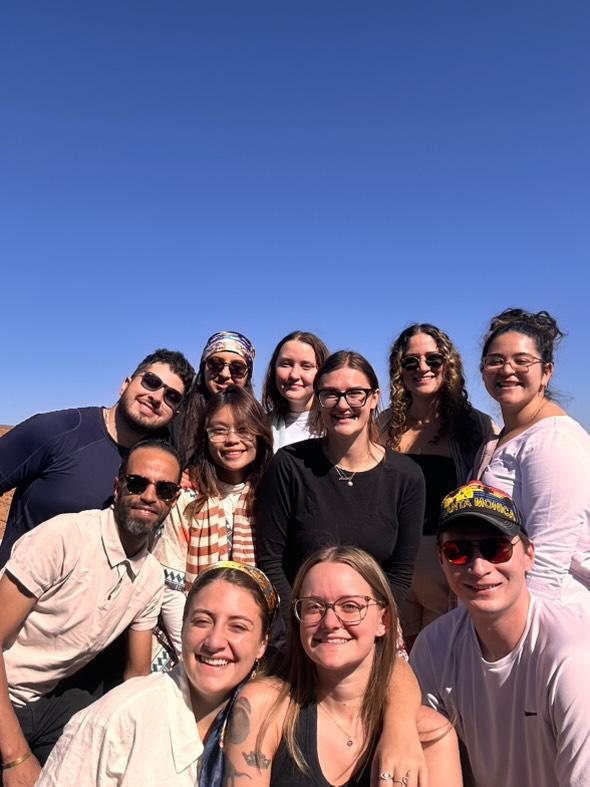 Group of young travellers smiling with their guide on a day trip